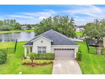 Charming single-story home with a well-maintained front yard and a view of the serene lake at 10836 Tilston Pt, Orlando, FL 32832
