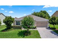 Charming single-story home with a paver driveway, attached garage, and well-manicured landscaping at 1431 Leitrim Loop, Apopka, FL 32703