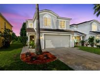 Charming two-story home with a well-maintained lawn and mature landscaping at 15324 Black Lion Way, Winter Garden, FL 34787