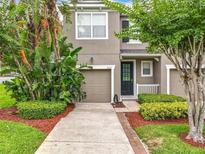 Two-story house with a front yard and a two-car garage at 2005 Compass Flower Way, Ocoee, FL 34761