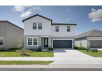 Charming two-story home with a well-manicured lawn and two-car garage in a suburban neighborhood at 2363 Lancashire St, Davenport, FL 33896