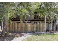 Charming townhome with a fenced-in yard and mature trees offering shade and privacy at 2636 Crown Ct, Kissimmee, FL 34741