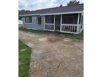 Charming single story home featuring a porch and a spacious driveway at 4 N Christiana Ave, Apopka, FL 32703