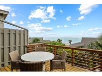 Outdoor deck with wicker furniture boasts ocean views at 4365 S Atlantic Ave # B8, New Smyrna Beach, FL 32169