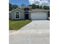 Charming single-story home with a well-maintained lawn and attached two-car garage at 4624 Via Veneto Ct, Kissimmee, FL 34746