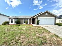 Charming one-story home featuring a two-car garage and well-maintained front yard and simple landscaping at 468 Rio Grande Ct, Kissimmee, FL 34759
