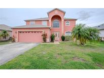 Charming two-story home with landscaped yard and a two car garage in a Gathering-friendly neighborhood at 547 Brighton Ct, Kissimmee, FL 34758