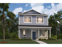Charming two-story home boasts a welcoming front porch and a beautifully landscaped front yard with lush green grass and palm trees at 5630 Stockade Blvd, St Cloud, FL 34771