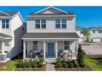 Charming two-story home featuring a welcoming front porch and beautifully landscaped front yard, perfect for curb appeal at 5630 Stockade Blvd, St Cloud, FL 34771