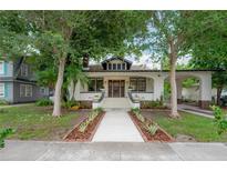 Charming vintage home featuring a welcoming front porch, landscaped yard, and attached carport at 622 S Ingraham Ave, Lakeland, FL 33801