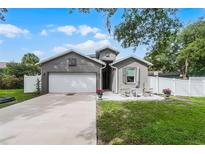 Charming gray single-Gathering home with a two-car garage and quaint front patio at 1020 Taproot Dr, Winter Springs, FL 32708
