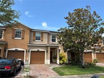 Charming townhome with attached garage, brick paved driveway, and well-maintained landscaping at 11187 Savannah Landing Cir, Orlando, FL 32832