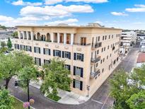 Elegant building with classic architecture, multiple balconies, and lush greenery enhancing its curb appeal at 140 E Morse Blvd # J, Winter Park, FL 32789