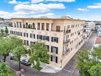 Building exterior featuring multiple balconies, shutters, and landscaping at 140 E Morse Blvd # J, Winter Park, FL 32789