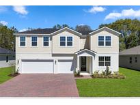 Charming two-story home with a three-car garage, manicured lawn, and inviting entrance at 3448 Douglas Fir Dr, Apopka, FL 32703