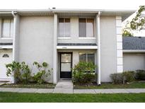 Charming townhouse featuring a well-maintained facade and a cozy entrance, and lush landscaping at 4364 White Pine Ave # 3, Orlando, FL 32811