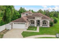 Charming home featuring a manicured lawn, covered entryway, and a two-car garage in a lovely neighborhood at 701 Little Hampton Ln, Gotha, FL 34734