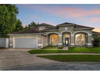 Charming single-Gathering home boasts a well-manicured lawn, inviting entrance, and a two-car garage at 701 Little Hampton Ln, Gotha, FL 34734