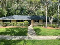 Charming single-story home featuring a stone facade and manicured landscaping for an inviting curb appeal at 955 Gamewell Ave, Maitland, FL 32751