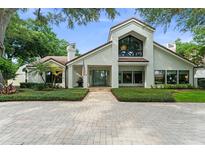 Stunning two-story home boasting a brick driveway, lush landscaping and charming architectural details at 9743 Chestnut Ridge Dr, Windermere, FL 34786