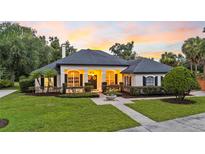 Beautiful single story home featuring manicured lawn, mature landscaping, and architectural details at 1141 Waldorf Ct, Winter Springs, FL 32708