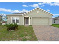 Lovely single-story home with brick driveway, manicured lawn and cozy front entrance for curb appeal at 189 Luxmore Rd, Groveland, FL 34736