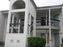 Exterior view of a condo building showcasing balconies, neutral paint, and architectural details at 2002 Cascades Blvd # 201, Kissimmee, FL 34741