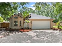 Charming single-story home with a well-manicured lawn, two-car garage, and a welcoming entrance at 30926 County Road 435, Sorrento, FL 32776