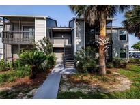Exterior of a condo building with beautiful landscaping and a well-maintained walkway at 3748 Idlebrook Cir # 202, Casselberry, FL 32707