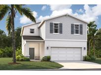 Charming two-story home features a classic design with a 2-car garage and well-manicured lawn at 4129 Lavender Ct, Lake Hamilton, FL 33851