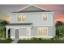 Charming two-story home with light gray siding, a covered entry, and well-maintained landscaping at 5045 Starling Bird Ln, St Cloud, FL 34771