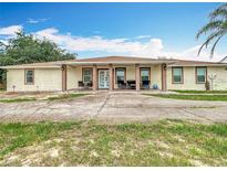 Charming one-story home with a long driveway and front porch offers curb appeal and ample parking at 516 Petes Ln, Davenport, FL 33837
