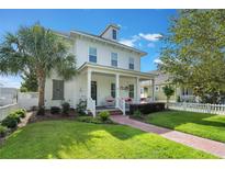 Charming two-story home with a welcoming front porch, lush lawn and well-manicured landscaping at 859 Easley Ave, Winter Garden, FL 34787