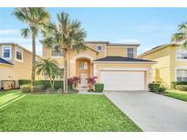 Charming two-story home features a well-manicured lawn and a two-car garage at 8622 La Isla Dr, Kissimmee, FL 34747