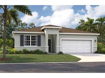 Charming single-story home featuring a two-car garage, front yard, and tropical landscaping at 928 Pearlwood Loop, Eagle Lake, FL 33839