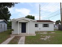 Charming single-story home featuring a driveway and inviting covered entrance at 102 Luna Rd, Auburndale, FL 33823