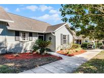 Landscaped walkway leads to a cozy home with tidy, well-maintained outdoor space at 1126 Villa Ln # 91, Apopka, FL 32712