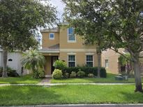 Charming two-story home with a well-maintained lawn and lush landscaping at 15208 Avenue Of The Arbors, Winter Garden, FL 34787