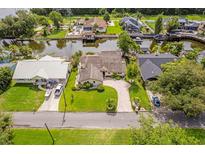 Stunning aerial view of waterfront home with lush landscaping, private dock, and beautiful curb appeal at 1721 Perch Ln, Sanford, FL 32771