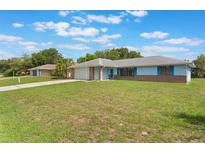 Charming one-story home with a well-manicured lawn and attached garage at 2290 Carson Ln, Deltona, FL 32738