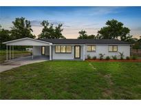 Charming single-story home with a well-manicured lawn and a convenient covered carport at 2549 Gress Ln, Lakeland, FL 33805