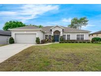 Charming single-story home with manicured lawn, attached garage and welcoming front entrance at 3956 Shadowind Way, Gotha, FL 34734