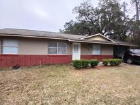 Charming single-story home featuring brick accents and a well-maintained front lawn at 4225 Ne 25Th Ave, Ocala, FL 34479