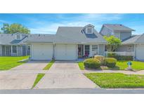 Charming home featuring a well-maintained lawn, two-car garage, and delightful curb appeal at 4545 Southfield Ave, Orlando, FL 32812