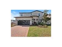 Charming two-story home with a brick driveway and attached two car garage at 5550 Sabal Dr, St Cloud, FL 34771