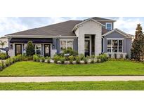 Charming single-Gathering home featuring a well-manicured lawn and stone accents at 842 Creeping Fig St, Apopka, FL 32703