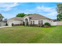 Well-maintained home exterior featuring a lush green lawn and neatly trimmed landscaping at 3956 Shadowind Way, Gotha, FL 34734