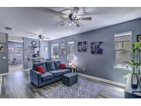Comfortable living room featuring a modern ceiling fan and a cozy blue couch at 114 Vista Verdi Cir # 116, Lake Mary, FL 32746