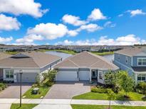 Beautiful single-story home with a three-car garage and lush landscaping at 13461 Panama Beach Ct, Orlando, FL 32827