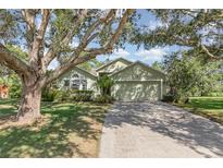Charming single-story home with a well-manicured lawn and mature trees, offering great curb appeal at 16103 Denham Ct, Clermont, FL 34711